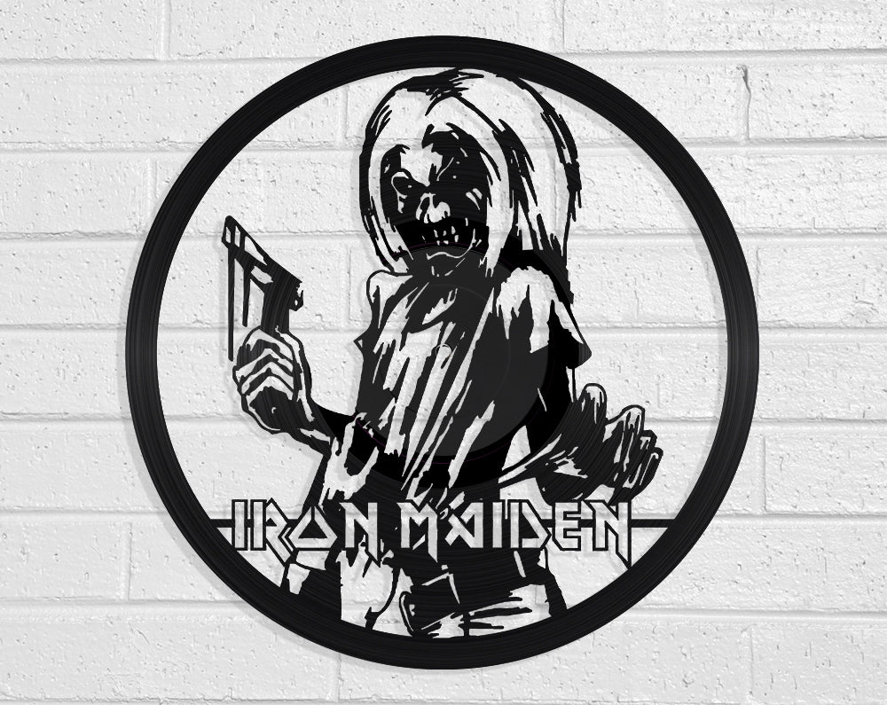 Vinyl LP Record art of Iron Maiden logo with skeleton holding a sword on a white brick wall by Revamped Records